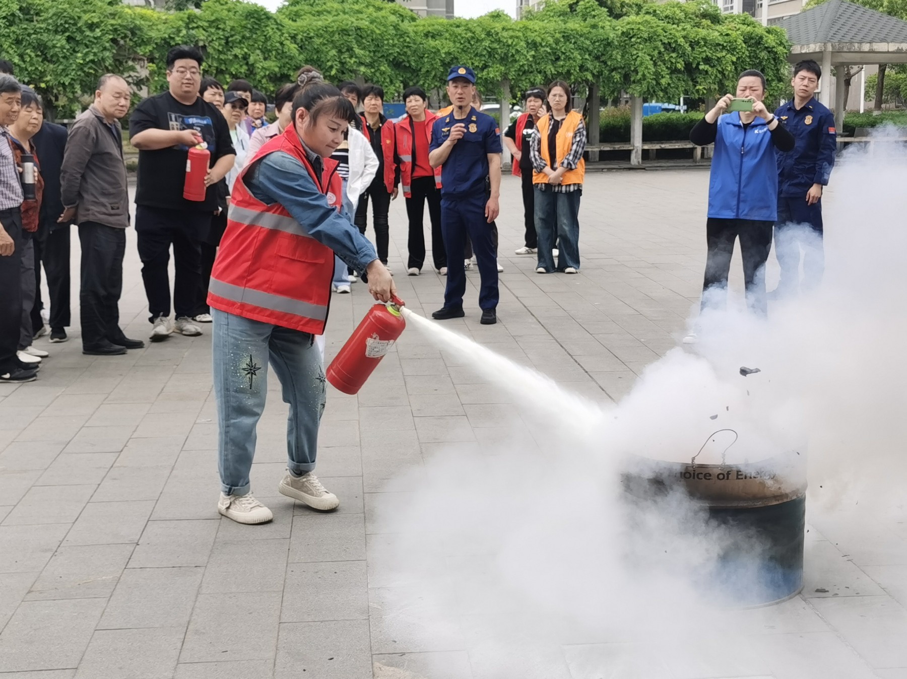 Employees practising fire‑extinguisher operation in simulated fire drill